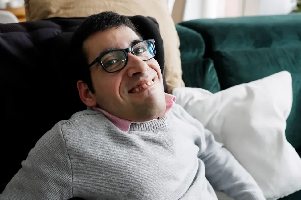 Happy disabled man smiling at camera